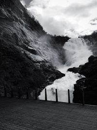 Scenic view of waterfall against sky