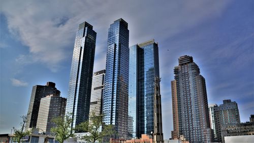 Low angle view of modern buildings against sky in city