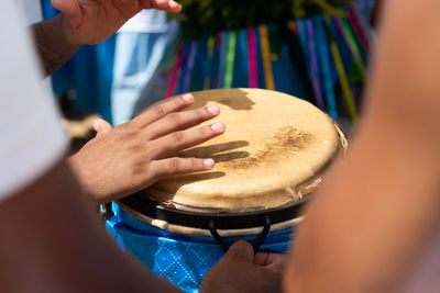 Percussionist hands playing atabaque.