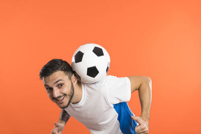 Low section of man playing soccer ball