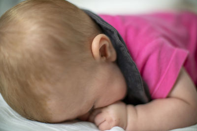 Close-up of baby sleeping on bed