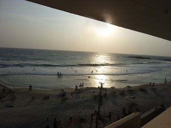 Group of people on beach at sunset