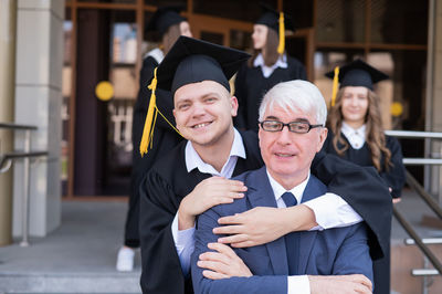 Portrait of man wearing graduation gown