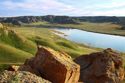 The ili river in the steppe against the background of low mountains and a sky on a sunny summer day
