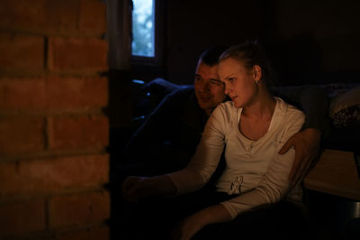 Smiling family in dark at home