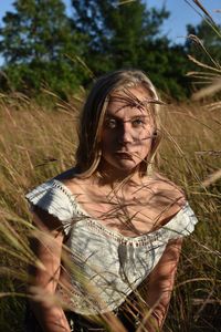 Portrait of a young woman in field