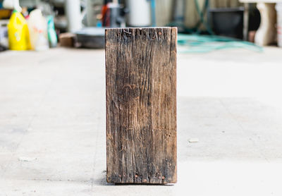 Close-up of wooden post on footpath