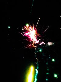 Low angle view of firework display at night