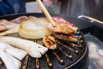 Close-up of meat on barbecue grill