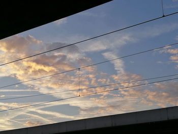 Low angle view of cables against sky