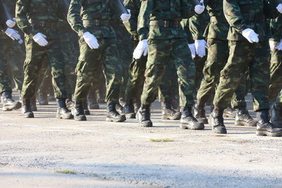 Low section of people walking on road