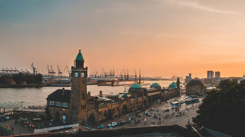 View of buildings in city against sky during sunset