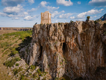 Rock formations on landscape against sky