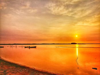 Scenic view of sea against romantic sky at sunset