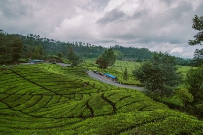 High angle view of field against cloudy sky