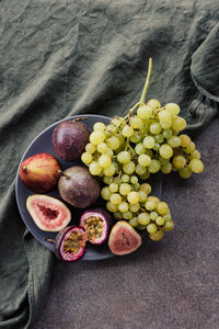 Platter of fresh grapes figs and passion fruit