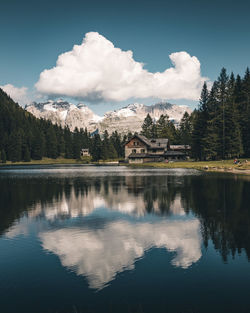 Scenic view of lake by buildings against sky