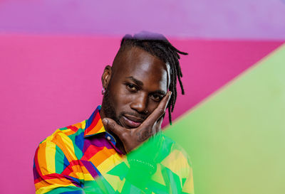 Portrait of young man against multi colored background