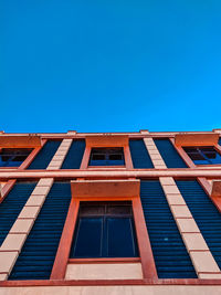 Low angle view of building against clear blue sky