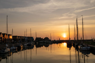 Sailboats in marina at sunset