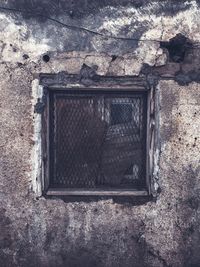 Close-up of window on wall of old building