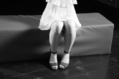 Low section of woman standing on tiled floor