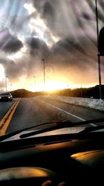 Car on road against sky during sunset