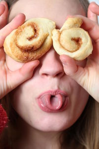 Close-up of woman covering eyes with sweet food