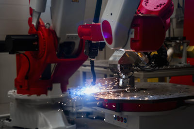 Close-up of automatic robot arm welding metal in factory