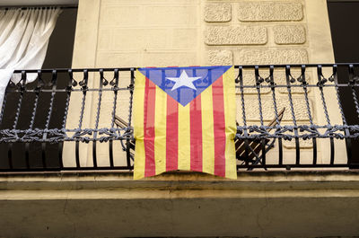 Low angle view of flag hanging on balcony 