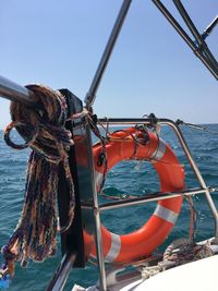 Close-up of rope tied on boat against sky