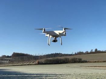 Airplane flying against clear blue sky