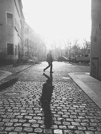 Full length of people walking on road in city