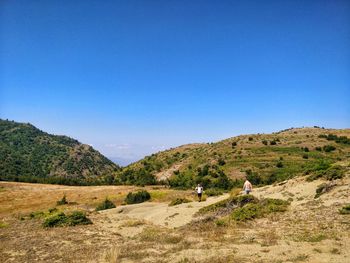 Scenic view of mountains against clear blue sky