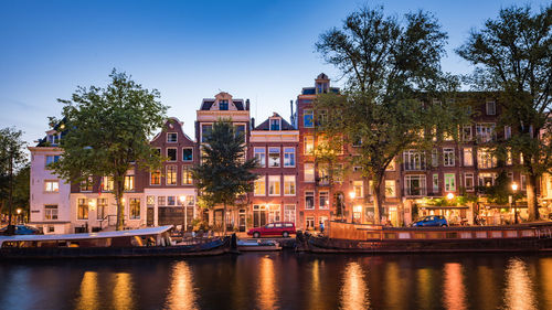 Boats in canal in city