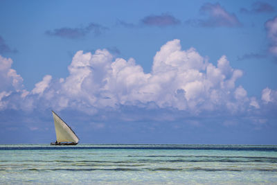 Sailboat in sea against sky