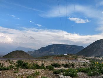 Scenic view of mountains against cloudy sky