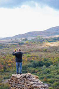 Rear view of man standing on mountain