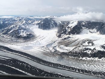 Aerial view of snowcapped mountains against sky