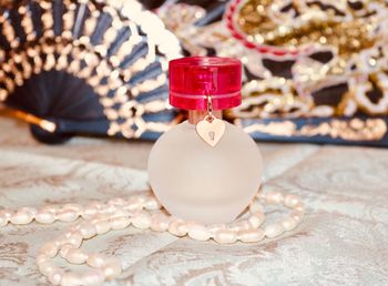 Close-up of  perfume bottle on table