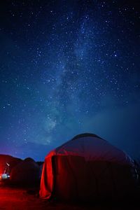 Scenic view of tent against sky at night