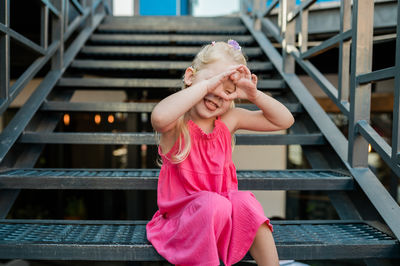 Portrait of young woman sitting on steps