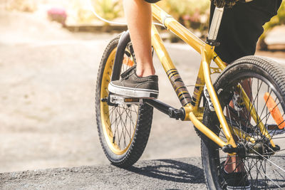 Low section of boy riding bicycle at sports ramp