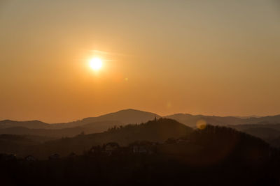 Scenic view of mountains against sky at sunset