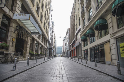 Empty alley amidst buildings in city