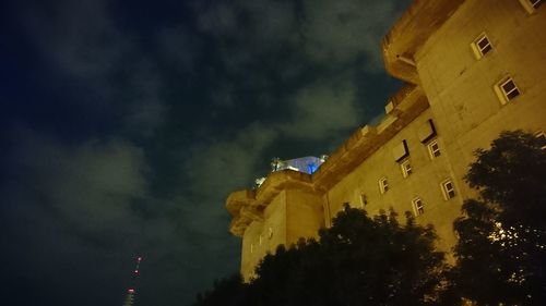 Low angle view of illuminated building against sky