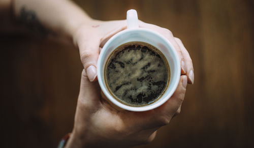 Woman holding coffee cup