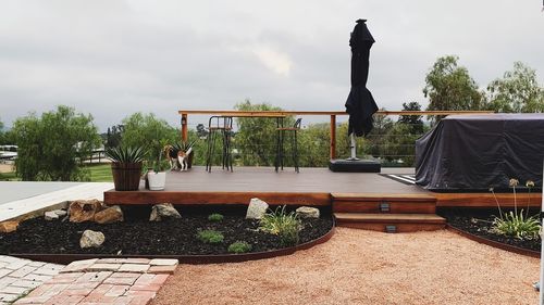 Statue on potted plants against sky