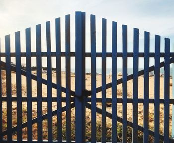 Row of fence against sky
