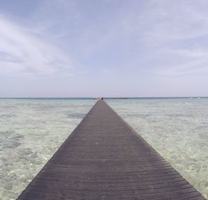 Pier over sea against sky